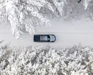 Truck driving in the snow in winter