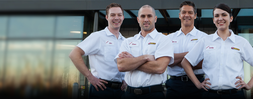 Les Schwab Employees in front of a store.