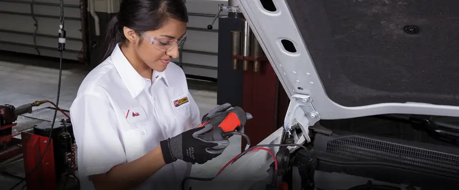 Les Schwab technician testing a battery