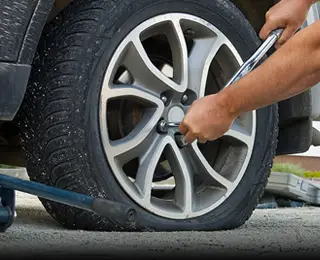 Person changing a flat tire