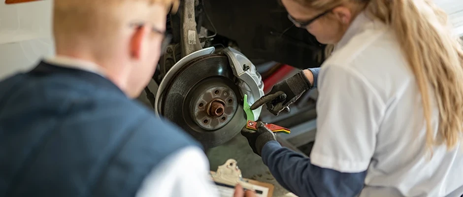 Technicians working on brakes