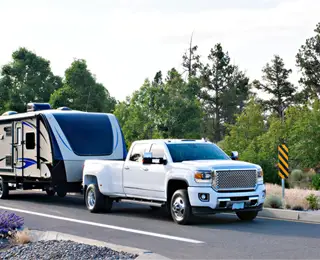 Truck Towing a Fifth Wheel Camp Trailer
