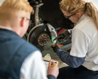 Les Schwab employee working on brakes