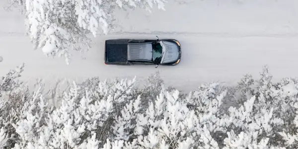 Truck driving in the snow in winter