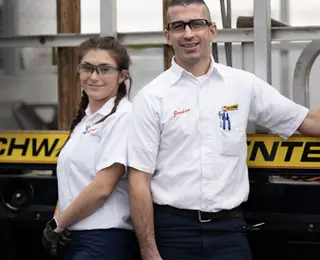 Les Schwab employees in front of service truck