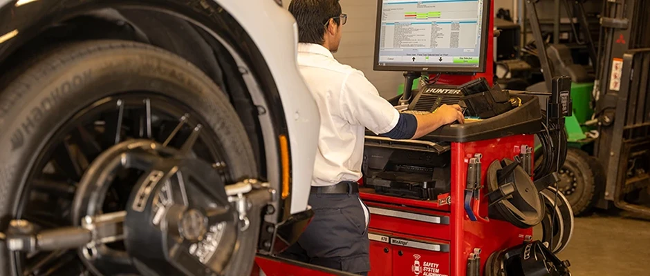 Technician working on the wheel alignment