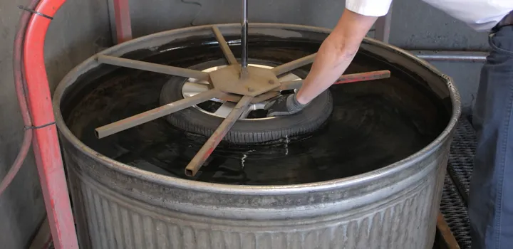 Dunking tire in water tank to check for leaks