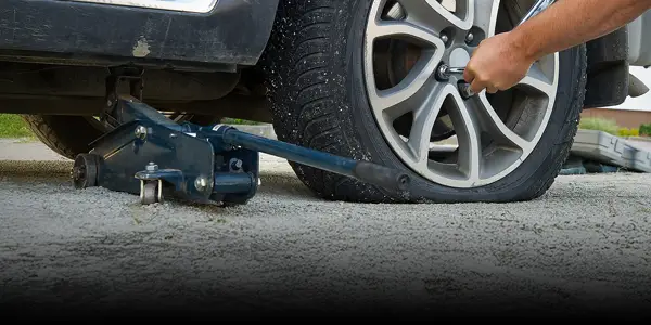 Person changing a flat tire