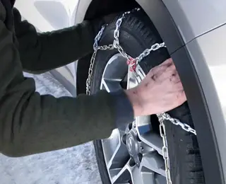 Man installing quick fit tire chain