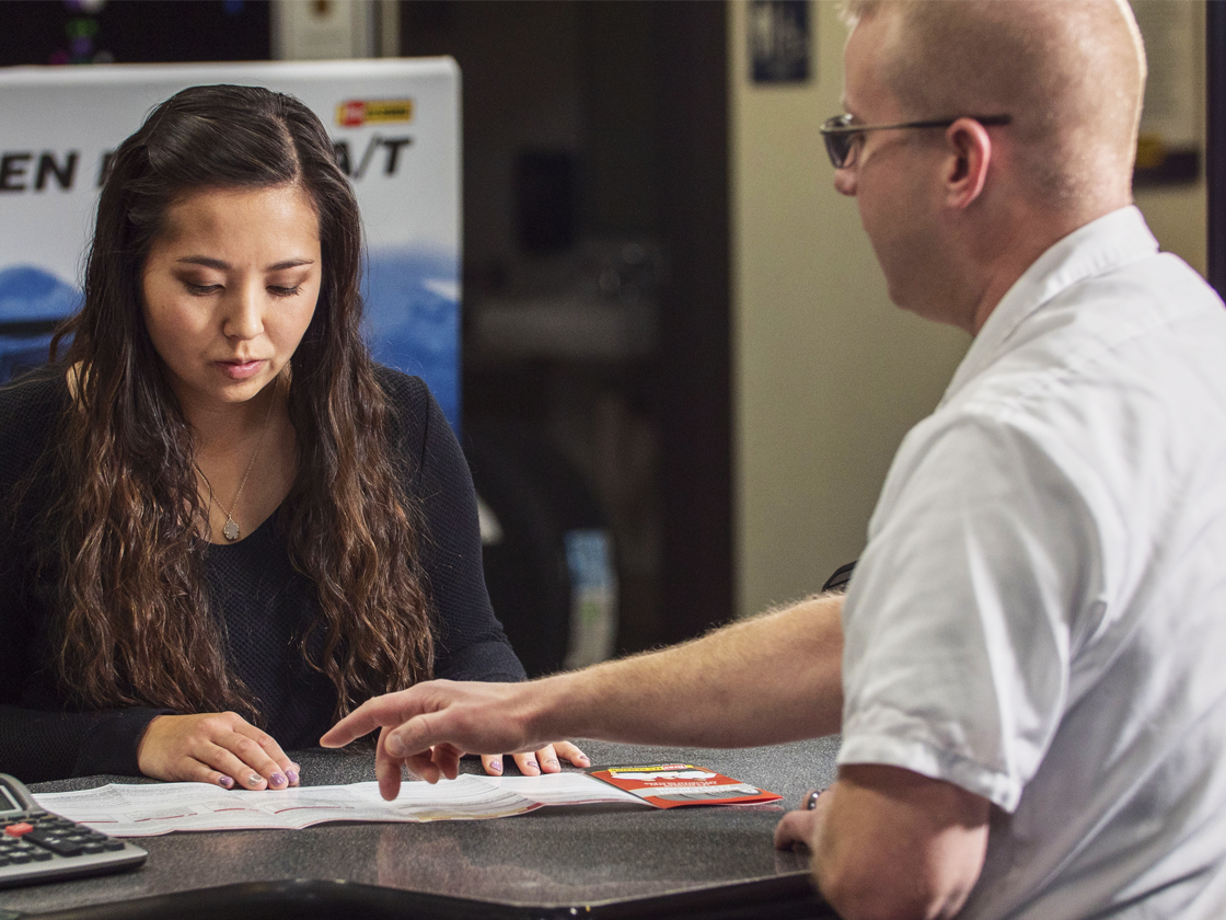 Customer and Les Schwab employee discussing credit options